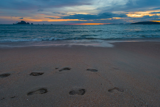 close-up of footprints in the sand, picture taken at sunset time