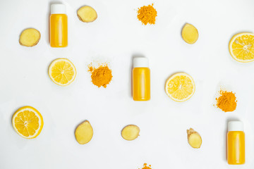 Ginger shot healthy drink with curd in a plastic bottle on white background. Immunity Boosting Tonic. Top View