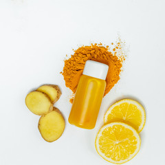Ginger shot healthy drink with curd in a plastic bottle on white background. Immunity Boosting...