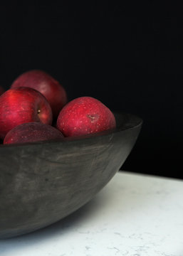 Red apples in wooden bowl