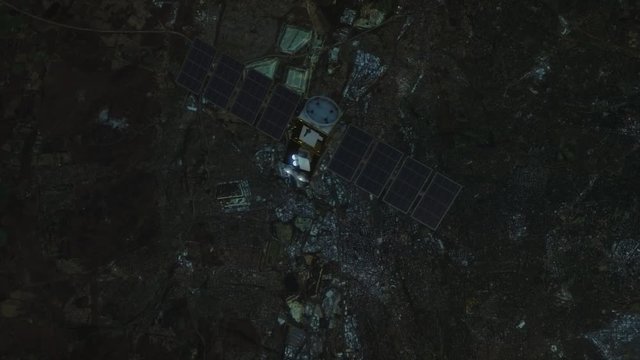 Satellite in low orbit over a city during a blackout.