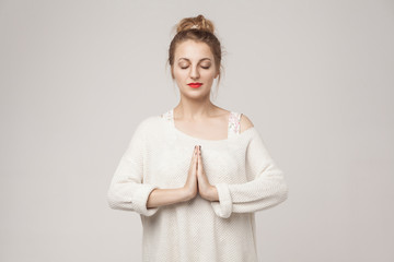 Blone young adult woman closed up, relax and pray.