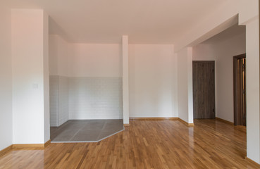Interior, domestic kitchen in empty apartment, parquet floor