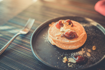 Morning table setup with pancakes and fruits