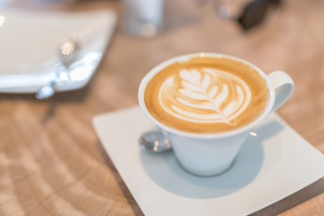 Latte art, coffee on wooden table background