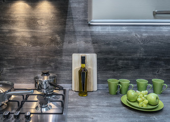 Modern kitchen in Loft style and bright green accents in the form of cups, apples and grapes. The...