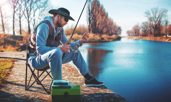 Angler enjoys in fishing on the river. Sport, recreation, lifestyle