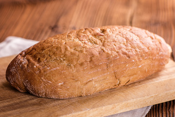 crusty fresh bread on a wood background