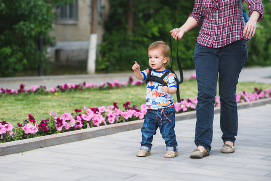 Mom insures her child during a walk