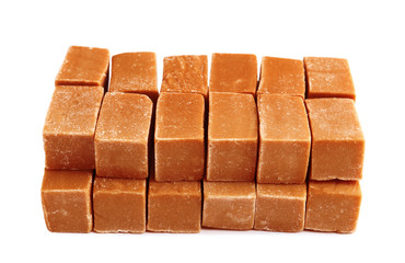 Delicious caramel candies on white background