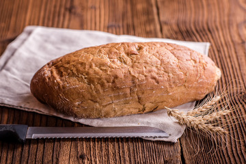 crusty fresh bread on a wood background