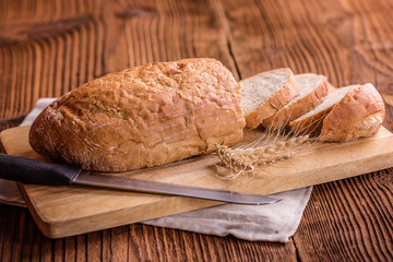 crusty fresh bread on a wood background