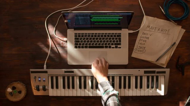 Top view stop motion of musician desktop recording track proccess at wooden desk