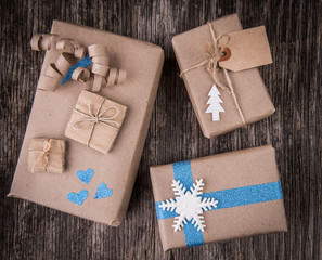 Closeup of boxes of gifts in natural paper rustic wooden table