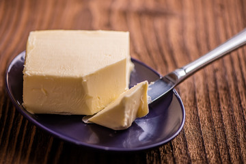 butter on a plate on old wood background