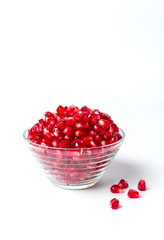 Pomegranate fruits in a bowl on white background