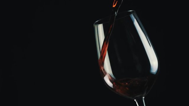 wine glass on black background slow motion video