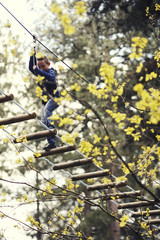 boy crossing high ropes