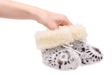 baby's bootees fur warming in female hands