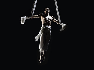 Male Aerialist performing Iron Cross © Eric