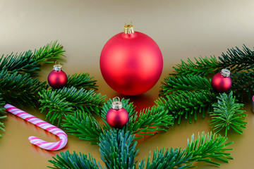 Christmas composition with red Christmas ball and fir branches.