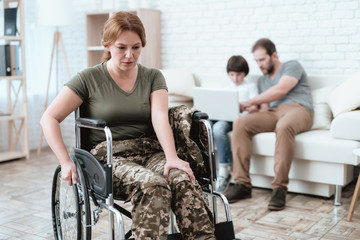 Woman veteran in wheelchair returned from army. A woman in a wheelchair is in pain. She's in military uniform. - obrazy, fototapety, plakaty