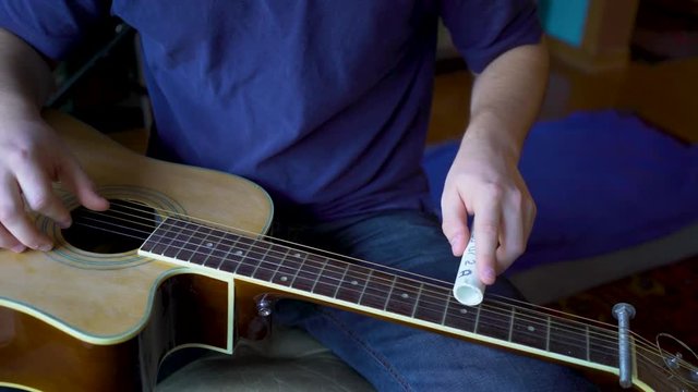 Six string slide guitar with pvc slider.