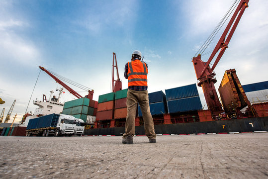 container ship in port terminal in duty loading discharging the contains tranfer the shipment from land to sea transportation for logistics systems services