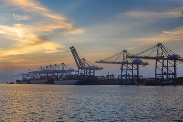 the vessel ships in port terminal are in loading and discharging containers cargo, services for export and import shipment to worldwild logistics