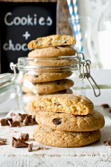 Chocolate chip cookies with milk on white background