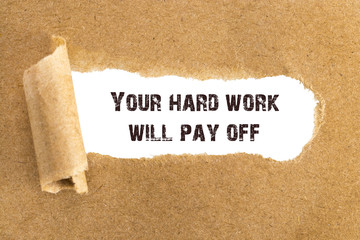 The text Your hard work will pay off appearing behind torn brown paper