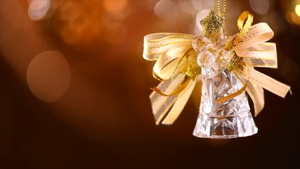 Christmas and New Year golden bell decoration. Abstract blinking holiday background. Slow motion 4K UHD video footage. 3840X2160