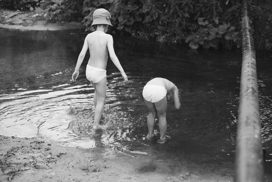 two sisters splashing by the water in the village
