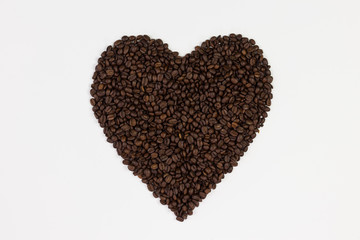 Coffee beans in a form of a heart isolated on white background.