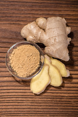 close up of a fresh ginger root on an old wood background