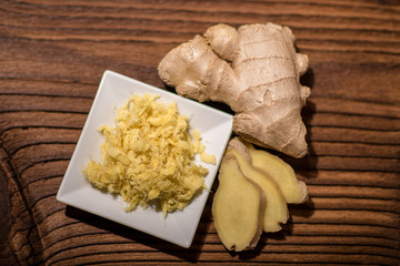 close up of a fresh ginger root on an old wood background