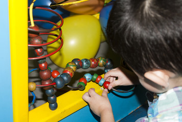 Fototapeta na wymiar Child in colorful playground, birthday party.