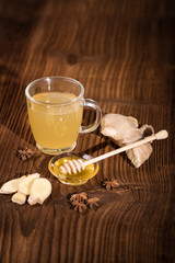 fresh ginger tea with honey on an old wood background