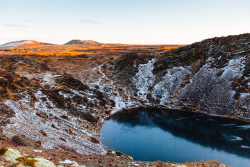 Top view of the Kerid crater with blue lake at sunrise. The Golden Circle tour. Iceland landscape.