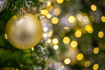 Fototapeta na wymiar Christmas ball hanging on abstract lights background