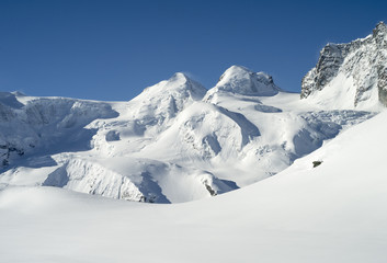 Naklejka premium snowed hills and glacier in mountains in Switzerland