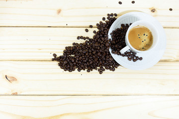 Coffee cup and coffee beans on wooden table