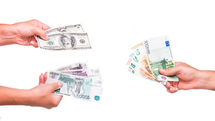 Hands exchange rubles and dollars for euros. People exchange currency, hands transmit money. Hand holds euro, dollar and ruble banknotes. Isolated on white background.