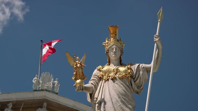 Vienna Parliament Pallas Athene in front of Austrian flag - long shot