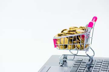 Shopping cart or supermarket trolley with laptop notebook on white background, e-commerce and online shopping concept.