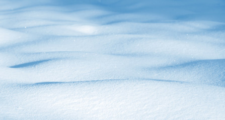 Natural background of pure shiny snow with snowdrifts