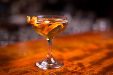 Bourbon whiskey cocktail in champagne saucer with orange twist garnish