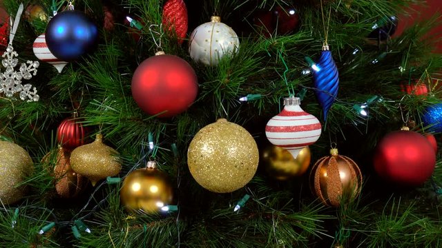 Festive Christmas Tree with brightl color decorations, close up focus on baubles, static.