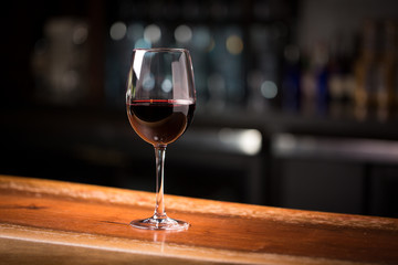 Glass of red wine on bar