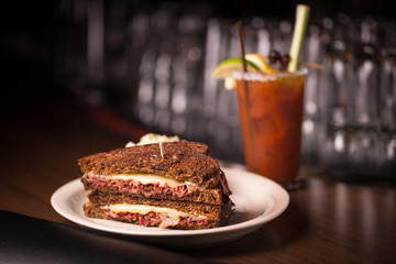 Diner style Ruben sandwich on rye bread with Bloody Mary cocktail